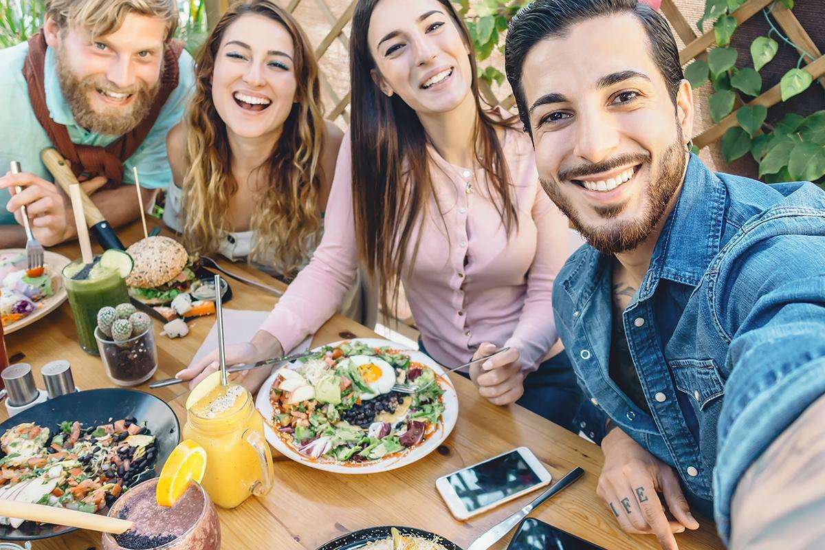 Happy Friends Taking Selfie With Mobile Smartphone While Lunchin